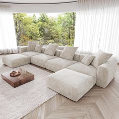 a large sectional couch sitting on top of a wooden floor in front of a window