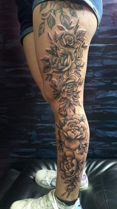 a woman's leg with flowers on it