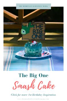 the big one smash cake is sitting on a plate with a sign above it that says,