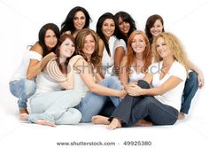 a group of beautiful women sitting next to each other on top of a white floor