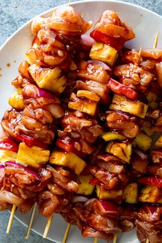 the skewers are covered with meat and vegetables on sticks, ready to be eaten