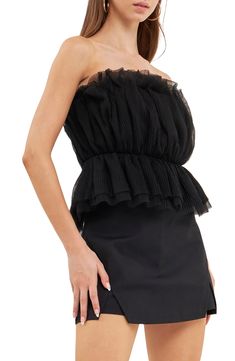 Turn up the drama with this textured tulle top featuring a strapless neckline and fabulous peplum. Strapless Lined 100% polyester Hand wash, dry flat Imported Chic Strapless Tube Top With Ruffles, Chic Strapless Ruffled Tube Top, Elegant Ruffled Bandeau Tube Top, Strapless Ruffled Tube Top For Night Out, Strapless Ruffled Tube Top For Date Night, Ruffled Bandeau Tube Top For Night Out, Chic Fitted Tulle Top, Strapless Ruffled Tops For Evening, Evening Strapless Tops With Ruffles