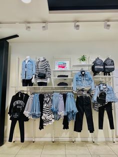 clothes are on display in a clothing store