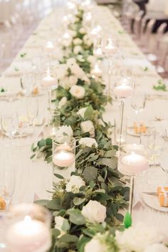 a long table with candles and flowers on it