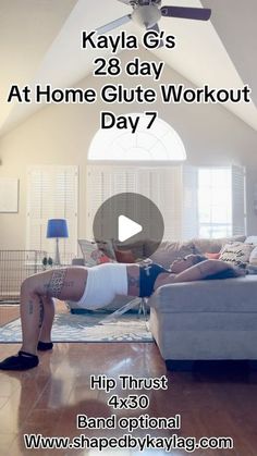 a woman laying on top of a couch in a living room next to a ceiling fan