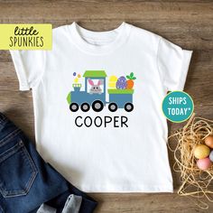 Personalized Easter Bunny Train Shirt, Toddler Custom Name T-Shirt, Cute Train Shirt for Kids (BUNNY TRAIN) PRODUCTION TIME Little Spunkies from the designer/owner of Spunky Pineapple Co https://www.etsy.com/shop/SpunkyPineappleCo   All baby and toddler clothes are 100% designed and printed with water based ink. All orders placed before 12:00 pm EST are shipped out same day (Monday - Friday). Orders received after noon are shipped out the next business day. ONESIES® BRAND  Made from 100% Cotton. We print on Onesies® Brand and do recommend ordering up one size as these run a little small after washing. T-SHIRT Made from 100% Cotton. These run true to size. If you are in between sizes we suggest sizing up. RAGLAN Made from 52% Cotton / 48% Polyester. These run true to size. If you are in bet Spring Letter Print T-shirt For Playtime, Spring Season Graphic Tee For Playtime, Spring Graphic Tee For Playtime, Playful Easter Short Sleeve T-shirt, Spring Playtime T-shirt With Character Print, Character Print T-shirt For Playtime In Spring, Spring Character Print T-shirt For Playtime, Cute Short Sleeve Easter T-shirt, Playful Short Sleeve Tops For Easter