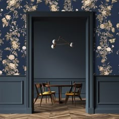 an open door leading to a dining room with floral wallpaper