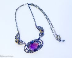 ~ 1920s gorgeous old brass filigree necklace with purple glass ~ Large faceted purple glass stone ~Old wonderful chain, paper clip style ~ Delicate enamel leaves ~ Excellent condition Length- 18" (45.5 cm) Drop when held- 8.5" (21.59 cm) More Fantastic Vintage Jewelry:  glennasvintageshop.etsy.com Additional Vintage in our sister shop Glenna's Jewels:  glennasjewels.etsy.com Instagram @glennas_clothing Facebook https://www.facebook.com/glennasclothing Antique Purple Metal Jewelry, Purple Filigree Pendant Necklace, Purple Pendant Necklace With Filigree, Formal Purple Metal Necklace, Purple Filigree Jewelry For Jewelry Making, Art Nouveau Purple Jewelry For Gift, Antique Handmade Purple Jewelry, Handmade Antique Purple Jewelry, Purple Art Nouveau Jewelry For Gift