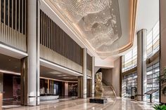 an elegant lobby with chandelier and marble flooring is pictured in this image