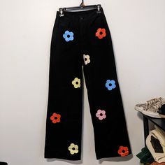 Brand New With Tags, In Perfect Condition. Cider Black High-Rise With Straight Wide Legs, Zipper, Button On Waistband, Belt Loops, Front And Back Pockets. Colorful Stamped Flower Shaped Daisies On The Front Only, Blue, Orange, Yellow, Pink. Inseam Is 28", Rise 11", Across The Waist Is 13", Size Xs. The Fabric And Care Tags Are Not On The Pants, But They Are On The Tag Hanging Off The Pants. All Cotton, No Stretch. Black Cotton Pants For Spring, Trendy Black Cotton Pants, Care Tag, High Rise, Flower Shape, Cider, Wide Leg Pants, Pant Jumpsuit, Wide Leg