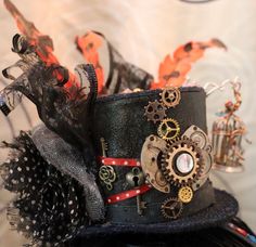 🎩Her name is "Bernice & Birdie" Small Black Top Hat on a Headband, adorned with gears, a small "caged mechanical bird" a colored broach with key, ribbon, colorful gems, feathers &  toole  My Punkadelic Headbands are One of a kind Frilly, Feathery, Fancy, Flowy & Funtastic and is sure to Punky up your Funky as you Gear up for any Event or Party!  ⚙️Every Punkadelic Item is One-Of-A-Kind, Handcrafted, Unique & Eclectic. Each Imperfectly Perfect Creations is Made with ❤️ &  My 🤲🏻.   🗝Please feel free to message me with any questions, for additional pictures of this item or If you are interested in a custom created commission top hat or headpiece. 💡Thank You for Peepin' my Punktastic pieces! Have a Technicolored Today 🤩 🧭 Fast and free shipping to the continental U.S. Vintage Handmade Costume Hats And Headpieces For Gifting, Handmade Adjustable Steampunk Costume Hats And Headpieces, Adjustable Vintage Top Hat As A Gift, Adjustable Vintage Costume Hats And Headpieces As Gifts, Vintage Black Mini Hats For Themed Events, Mechanical Bird, Casino Costumes, Steampunk Top, Surprise Birthday Gifts