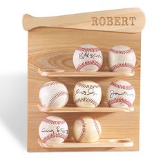 a wooden plaque with baseballs on it and the name robert written on one of them