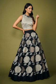 Black skirt with silver floral applique embroidery. Paired with silver top.
Component: 2
Pattern: Embroidery
Type Of Work: Floral
Neckline: Round
Sleeve Type: Sleeveless
Fabric: Silk
Color: Black
Other Details: 
Flared skirt
Note: Necklace worn by the model is not for sale
Occasion: Sangeet - Aza Fashions Silver Fitted Designer Dress, Silver Dress With Intricate Embroidery, Party Wear Skirt With Zari Work, Elegant Party Skirt With Zari Work, Festive Embellished Long Skirt, Silver Choli With Cutdana For Party, Elegant Navratri Skirt For Reception, Silver Party Choli With Cutdana Details, Elegant Festive Skirt For Navratri