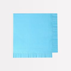 two blue napkins on top of each other with fringe ends in different colors and sizes