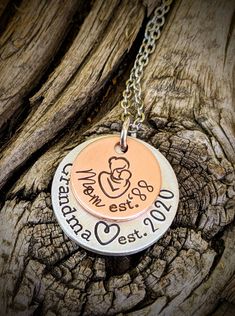 "Personalized hand stamped grandma necklace. Gift for grandma. Custom mothers day gift for grandma. Nana necklace. Memaw gift. First time grandma gift. Pregnancy announcment to mom. Custom pregnant announcement. Hand stamped and made to order. Made from a 5/8\" copper disc, stamped with a mama and baby stamp and stamped with the phrase, \"Mom est. (year of your choice),\" then a 7/8\" aluminum disc, stamped with the phrase, \"grandma est. (year of your choice).\" Stacked together and attached to Hand Stamped Round Necklaces For Mother's Day, Hand Stamped Round Necklace For Mother's Day, Meaningful Hand Stamped Necklace For Mom, Hand Stamped Necklace For Mother's Day, Meaningful Stamped Necklace For Mother's Day, Meaningful Stamped Necklaces For Mother's Day, Hand Stamped Necklace For Father's Day, Birthday Jewelry For Mother's Day, Adjustable Hand Stamped Necklaces For Anniversary Gift