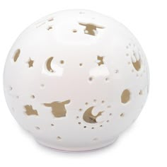 a white ceramic ball with holes in the middle and stars on it's surface