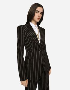 Pinstripe wool Turlington blazer: Peak lapels Long sleeves Flap pockets Leopard-print stretch satin lining Canneté-covered button fastening with DG logo The piece measures 70 cm from the rear collar seam on a size IT 40 The model is 175 cm tall and wears a size IT 40 Made in Italy Luxury Striped Blazer For Formal Occasions, Luxury Striped Long Sleeve Blazer, Luxury Fitted Pinstripe Outerwear, Formal Striped Fitted Blazer, Luxury Striped Outerwear For Formal Occasions, Luxury Striped Formal Outerwear, Chic Striped Formal Blazer, Chic Striped Blazer For Formal Occasions, Striped Tailored Blazer With Lapel Collar