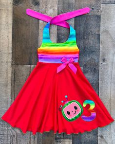 This cute Cocomelon dress would be perfect for a Cocomelon theme birthday party. Dress is made out of a nice comfy knit with a rainbow print top bocice. Dress can be personalized with number or initial of your choice. Cocomelon Birthday Dresses, Whimsical Summer Rainbow Dress, Fitted Multicolor Dress For Birthday, Fun Rainbow Dress For Playtime, Fun Rainbow Playtime Dress, Cute Rainbow Dress For Summer, Rainbow Dress For Birthday In Spring, Rainbow Dresses For Birthday In Spring, Playful Multicolor Birthday Dresses