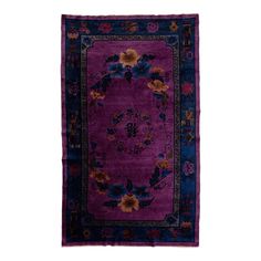 a purple rug with flowers and leaves on the bottom, in front of a white background