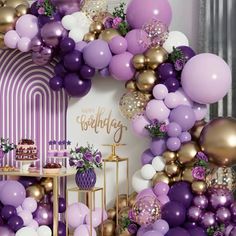 a purple and gold birthday party with balloons