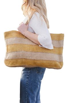 Perfect for an afternoon at the market, a day at the beach or a weekend adventure, this packable jute tote makes an ideal companion on any outing. It's handwoven in Bangladesh using traditional techniques and botanic dyes that give it an earthy, one-of-a-kind look and feel. 23"W x 14"H x 4"D Jute Spot clean Imported Fair Trade Jute Beach Bag For Travel, Artisan Summer Bags For Everyday Use, Artisan Bags For Everyday Summer Use, Fair Trade Summer Beach Bag For Travel, Artisan Bags For Summer, Beige Fair Trade Beach Bag For Market, Handwoven Jute Beach Bag For Travel, Travel Beach Bag, Handwoven Jute, Fair Trade Beige Beach Bag For Market