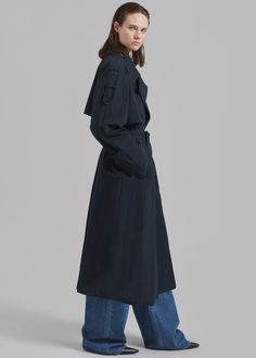 Color: Navy Midweight woven fabric Relaxed fit Notch lapel Storm flap Cape panel detailing at back Button cuffs Vented back Sleeve loops Front pockets Front button closure Lined 70% Cotton 30% Polyamide Dry Clean Only Imported Navy Trench Coat, Denim Suit, Winter Trench Coat, The Frankie Shop, Frankie Shop, Double Breasted Trench Coat, Maxi Coat, Paris Woman, Swimwear Accessories