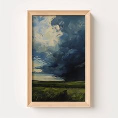 a painting hanging on the wall next to a white wall with a wooden framed frame