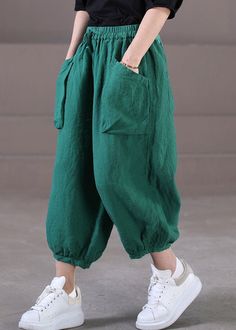 Baggy Straight Harem Pants In Solid Color, Baggy Solid Color Harem Pants, Spring Baggy Solid Parachute Pants, Green Baggy Parachute Pants For Spring, Baggy Green Wide Leg Pants With Elastic Waistband, Spring Solid Color Harem Pants With Cargo Pockets, Green Summer Harem Pants With Pockets, Spring Green Loose Fit Wide Leg Pants, Spring Baggy Cargo Pants In Solid Color