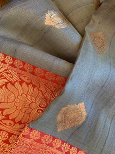 A stunning combination of light gray and red in this pure silk tussar benarasi saree. This combination is very unique and special, and is hard to find. The body is a steel gray with contrast rich red pallu and border, and golden zari benarasi weaving. The fabric is pure silk tussar (Silk Mark Certified) and is very luxurious and sturdy. Saree has a beautiful glow reflecting from the golden zari as well as from the tussar yarns. This saree has been woven in a handloom by weavers in Varanasi, Indi Gray Traditional Wear For Wedding And Festivals, Gray Chanderi Traditional Wear For Festive Occasions, Gray Saree With Zari Work For Wedding, Gray Traditional Wear For Festive Occasions, Festive Gray Saree For Wedding, Gray Festive Traditional Wear, Festive Gray Traditional Wear, Traditional Gray Saree With Pallu, Traditional Gray Dupatta With Traditional Drape