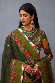 Olive green full sleeves anarkali with all over gullista digital print and gota lace, heart charms and metallic coins hand embroidery on the yoke. Paired with a churidar and a hand embroidered-printed matching dupatta with multi thread tassels border detailing. - Aza Fashions Green Long Sleeve Churidar For Eid, Green Churidar With Resham Embroidery And Long Sleeves, Green Long Sleeve Anarkali Set With Resham Embroidery, Green Long Sleeve Chanderi Churidar, Green Long Sleeve Churidar With Resham Embroidery, Traditional Pista Green Anarkali Set With Long Sleeves, Traditional Pista Green Long Sleeve Anarkali Set, Traditional Pista Green Long Sleeve Salwar Kameez, Traditional Long Sleeve Salwar Kameez In Pista Green