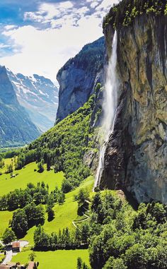 an aerial view of a mountain with a waterfall coming out of the side of it