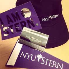 purple and black hats are sitting on a table next to other items that say i am stern