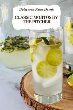 two glasses filled with lemonade and limes on top of a wooden tray next to pitcher