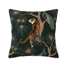 a decorative pillow with a tiger and peacock on the front, sitting in a tree