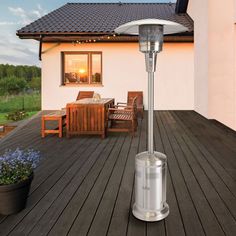 an outdoor patio heater sitting on top of a wooden deck