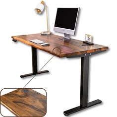 a computer desk with a monitor, keyboard and mouse on it next to a lamp