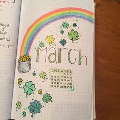 an open planner with shamrocks and a pot of gold on the cover, which reads march