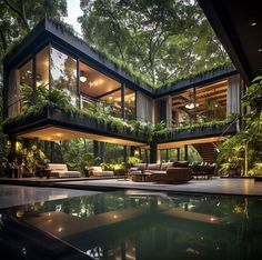 a large house with lots of windows and plants growing on the roof, next to a swimming pool