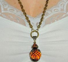 Adjusted on demand, Long brass chain pendant necklace, amber faceted pendant, amber faceted pendant, funky rustic boho pendant, bohemian jewelry, gift for her I made this pendant with a beautiful faceted amber glass crystal bead with brass bead caps on the top and bottom (these may differ slightly from the picture) There is another faceted amber crystal bead of smaller dimension above. Linked to a floral brass bead ring that connects to an antiqued brass chain that measures 22 inches long. It ha Funky Necklaces, Brass Pendant Necklace, Funky Necklace, Xmas Gifts For Her, Amber Crystal, Purple Agate, Boho Pendant, Rustic Boho, Glass Pendant Necklace