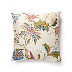 a white pillow with colorful flowers on the front and back, against a white background