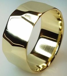 a close up of a gold ring on a white surface