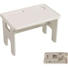 a white plastic table with a hole in the middle and a small piece of paper underneath it