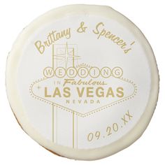 the las vegas wedding souvenir is shown in white and gold with golden lettering