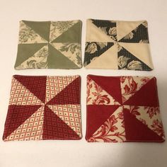 four square pieces of fabric sitting on top of each other