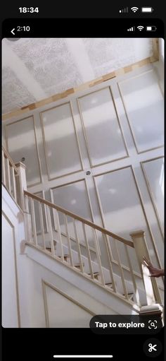 a stair case with glass doors and white railings