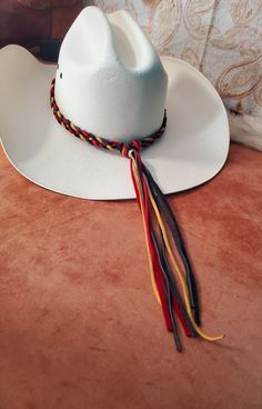 Custom Deerskin Braided Leather Hatband.  Deerskin is available in Turquoise, Natural, Light Brown, Saddle Brown, Red, Blue, Black, Gold, Grey, Whtie or Dark Brown.  Hatband is adjustable by sliding the bead at the end of the braid after the knots. These custom deerskin hats can be made from 1/4" or 1/8" deerskin.  I keep a lot of colors in stock, but others can be ordered.  Add your custom centerpiece.  Tell me what you want and let's created something together.   See my other hatbands:   https://www.etsy.com/shop/BlueEyesDesignsHB?ref=shop-header-name&listing_id=1476946144&section_id=31618272 See Custom Hat Band Listing:  https://www.etsy.com/listing/1239791038/custom-western-cowboy-cowgirl-hat-band?click_key=a8f27a46910e80585f9a75cc01cce729f063234b%3A1239791038&click_sum=98b927d5&ref=sh Hair Keepsake, Boot Bracelet, Leather Hat, Cowgirl Hat, Saddle Brown, Cowboy Cowgirl, Leather Hats, Red Turquoise, Cowgirl Hats