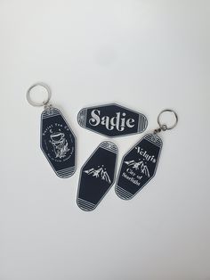 three keychains with the words suffic on them are laying next to each other