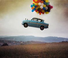 an old car is flying with balloons in the sky