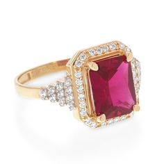 a gold ring with a red stone surrounded by diamonds