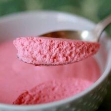 a spoon with pink powder in it